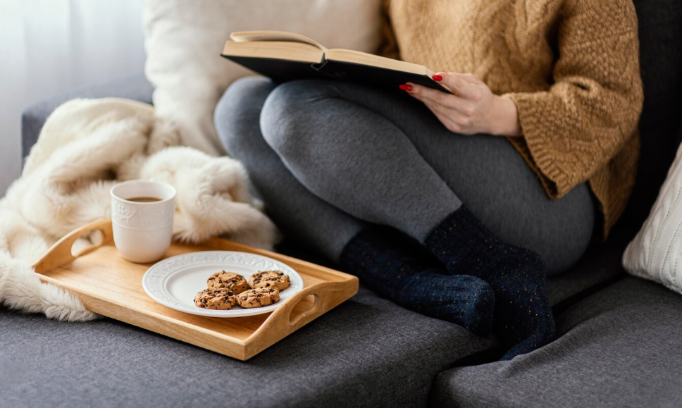 Cozy reading scene at home showing the slow living movement at home.