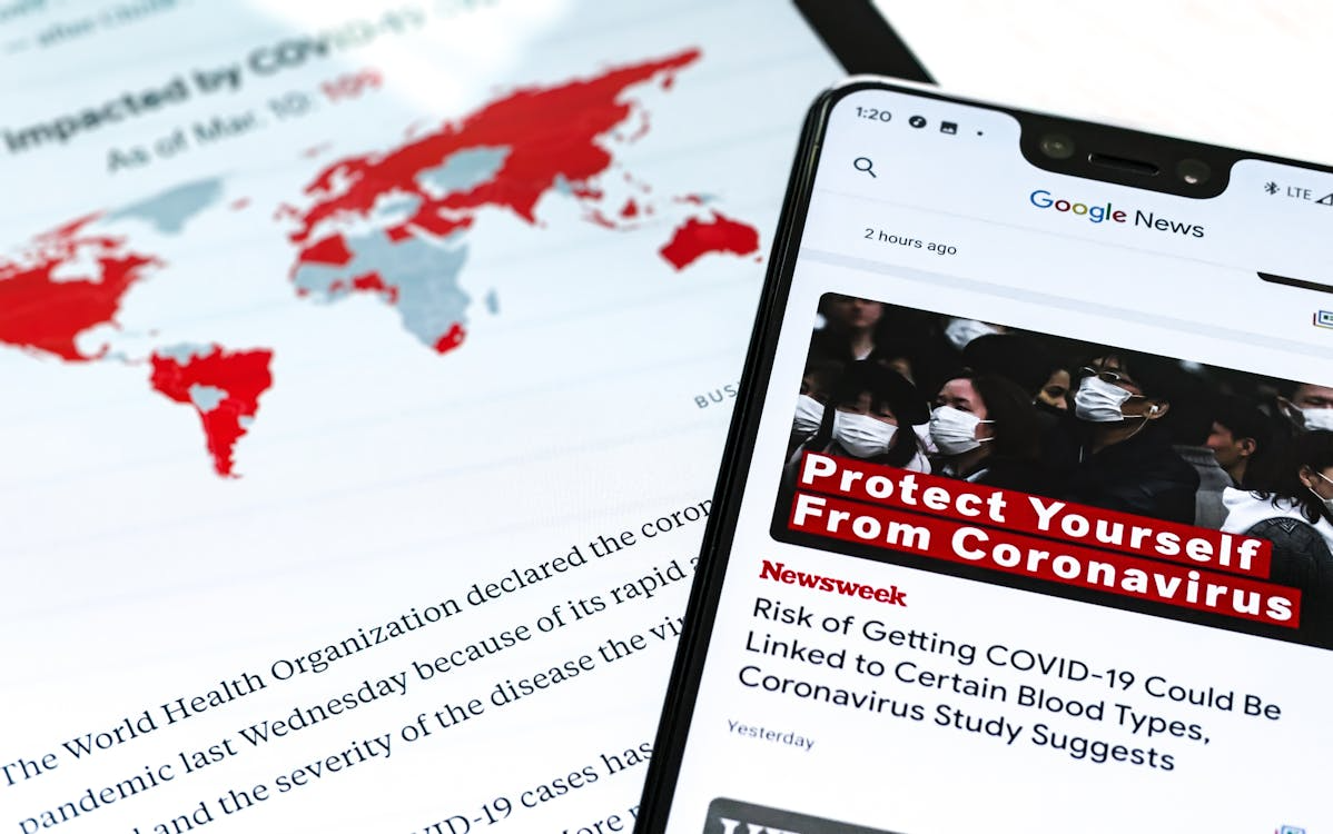 Phone showing news aggregation online through Google News headlines.