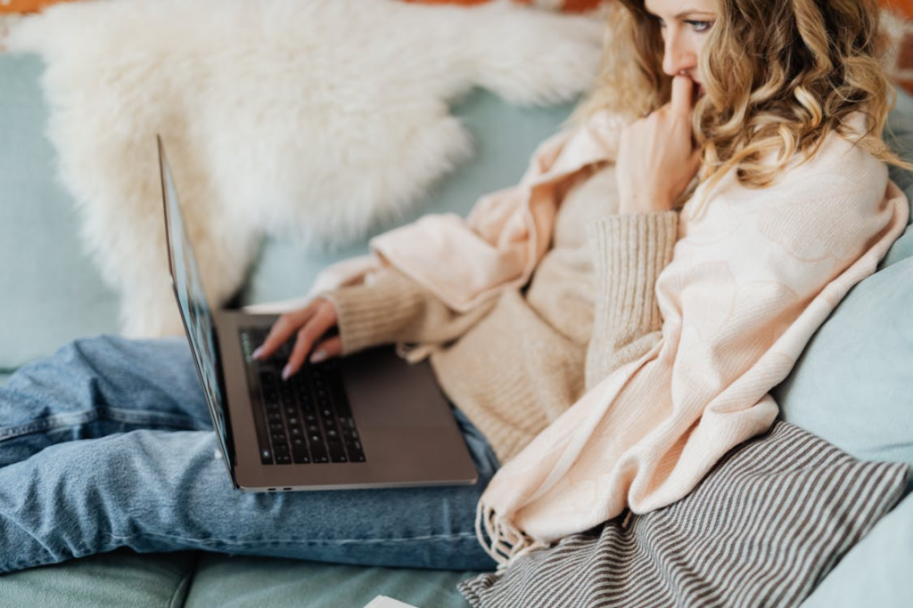 Viewer using a laptop in a cozy setting showing why comfort content is popular.