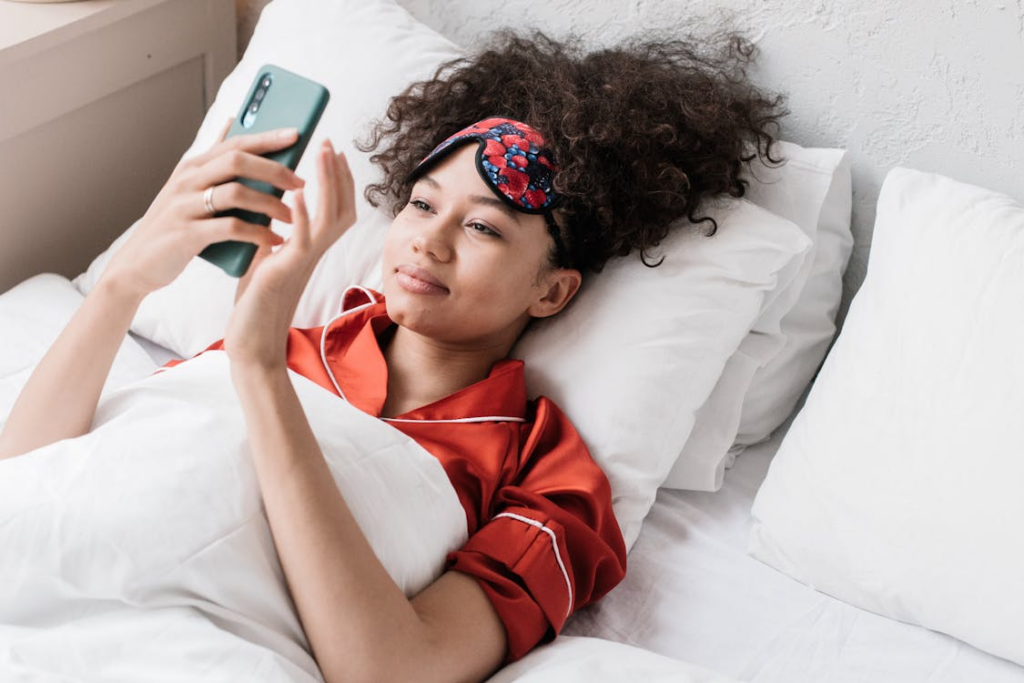 Woman checking her phone in bed illustrating why people want quick information.