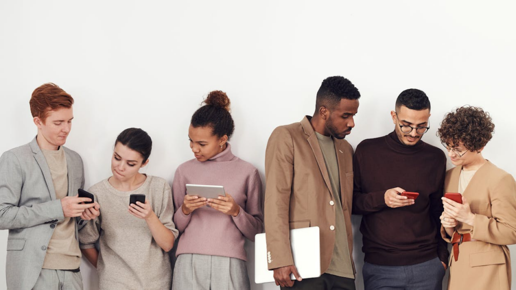 Group using phones showing why internet trends go viral.