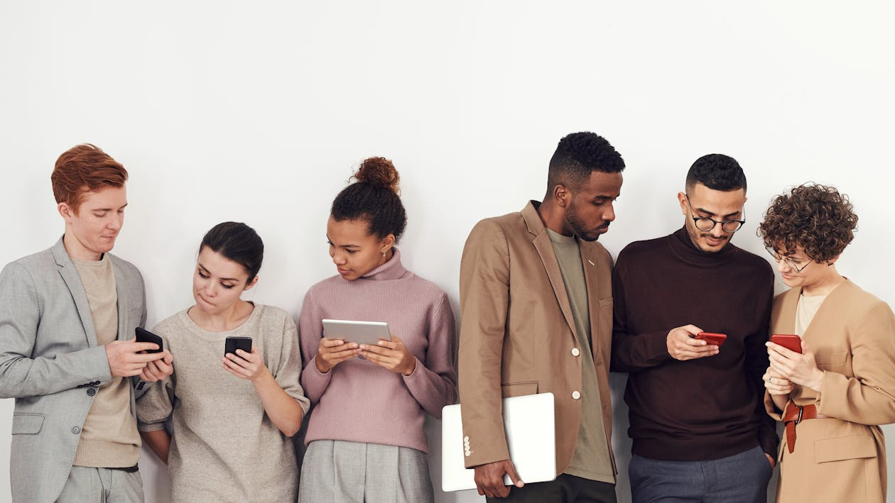 Group using phones showing why internet trends go viral.