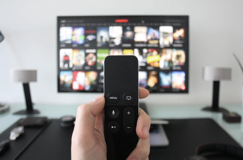 Remote pointed at a TV showing how streaming changed entertainment.